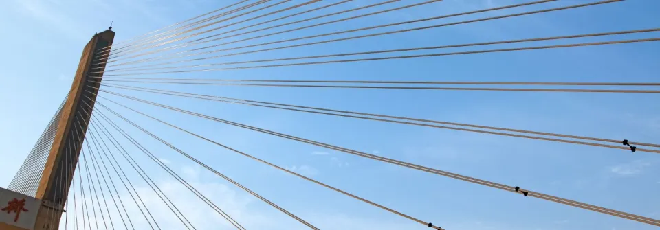 a suspension bridge against a blue sky